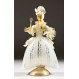 A VENETIAN MOULDED GLASS FIGURE OF A WOMAN, formed from opaque, clear and gilded glass. 8.5ins