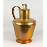 A LARGE BRASS AND COPPER CHURN, with strap handle and lid. 23ins high.