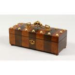 A 19TH CENTURY FRENCH WALNUT AND EBONY BANDED BOX, with ornate ormolu handle and studded decoration.