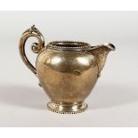 A CONTINENTAL SILVER CREAM JUG. 3.5ins high.