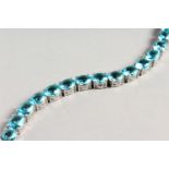 A SILVER BLUE TOPAZ LINE BRACELET.