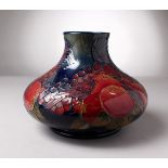 A LARGE MOORCROFT BLUE POTTERY BULBOUS VASE, "Pomegranates and Birds". Signed Masy. 10ins diameter x