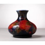 A MOORCROFT POTTERY BULBOUS VASE, blue ground with pomegranates and fruit. Impressed MOORCROFT, W.