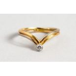 AN 18CT GOLD DIAMOND SET WISHBONE RING.