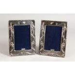 A PAIR OF SILVER ART NOUVEAU DESIGN PHOTO FRAMES. 7.25ins x 5.5ins.