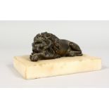 A SMALL CAST BRONZE MODEL OF A RECUMBENT LION, on a marble base. 5ins long.