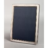 A PLAIN SILVER UPRIGHT PHOTOGRAPH FRAME. 8ins x 6ins.