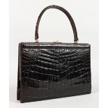 A BLACK CROCODILE SKIN HANDBAG, 10ins.