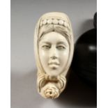 A MEERSCHAUM PIPE OF A LADY WEARING A HEADSCARF, cased.