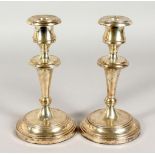 A PAIR OF CIRCULAR SILVER CANDLESTICKS. Stamped Argentina 925, 32ozs, weighted bases. 8.5ins high.