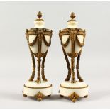 A PAIR OF ORMOLU AND MARBLE "CASSOLETTES", with pineapple finials, ram's masks, on circular bases.