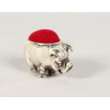 A TINY NOVELTY SILVER PIG PIN CUSHION.