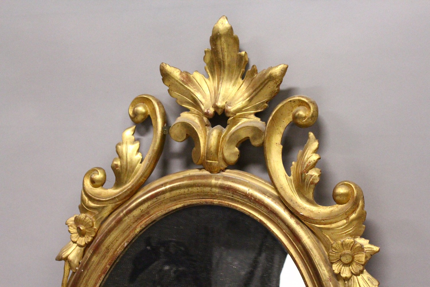 A 19TH CENTURY OVAL GILT FRAMED MIRROR, with carved cresting. 2ft 10.5ins high x 1ft 9ins wide. - Image 2 of 4