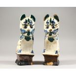 A PAIR OF POTTERY CAT CANDLESTICKS. 7.5ins high.