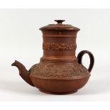 A BROWN GLAZED TERRACOTTA TEAPOT, with filter and moulded decoration. 7.5ins high.