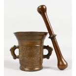 A CAST BRONZE TWIN-HANDLE PESTLE AND MORTAR, with engraved decoration, initialled CM, dated 1700.