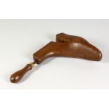 A 19TH CENTURY WOODEN BOOT TREE, with turned handle. 8.5ins long.