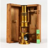 A SMALL MAHOGANY CASED BRASS MICROSCOPE. Box: 6.5ins long.