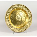 A 19TH CENTURY EMBOSSED BRASS ALMS DISH, "KANE AND ABEL". 18ins diameter.