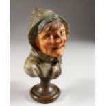 A CONTINENTAL PAINTED TERRACOTTA BUST OF A WOMAN WEARING A HEAD SCARF. 5.5ins high.