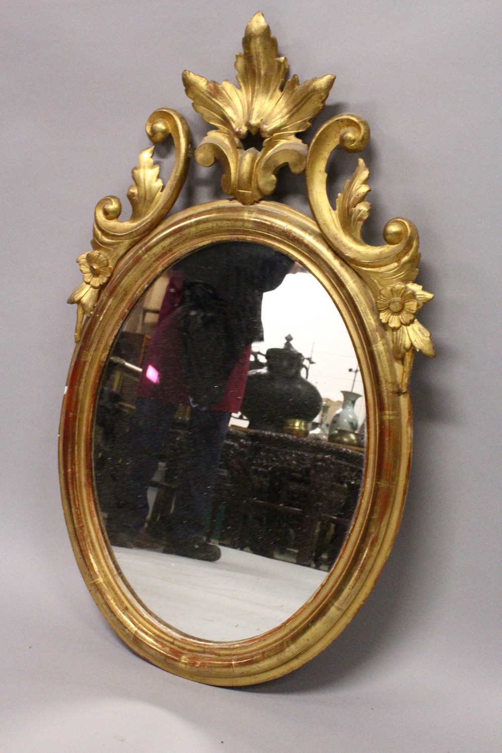 A 19TH CENTURY OVAL GILT FRAMED MIRROR, with carved cresting. 2ft 10.5ins high x 1ft 9ins wide. - Image 3 of 4