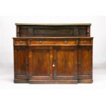 A REGENCY MAHOGAN BREAKFRONT SIDEBOARD, the gallery top with a brass rail, over a long frieze drawer