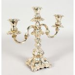 A CONTINENTAL SILVER TWO BRANCH CANDLESTICK, with loaded bases. 12ins high.