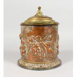 A 19TH CENTURY BRASS AND COPPER TOBACCO JAR AND COVER, decorated with cherubs and other classical