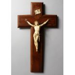 A 19TH CENTURY IVORY CORPUS CHRISTI, mounted on a brass inlaid rosewood crucifix. 13.75ins high.