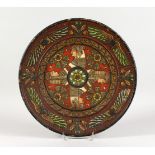 A CONTINENTAL PAINTED TERRACOTTA CIRCULAR DISH, in the Egyptian Revival style. 14ins diameter.