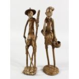 A PAIR OF NATIVE BRONZE LONG FIGURES. 12ins high.