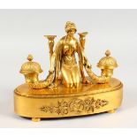 A SUPERB FRENCH EMPIRE ORMOLU OVAL INKSTAND, the top with a classical female figure holding a pair
