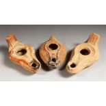 THREE ROMAN TERRACOTTA OIL LAMPS.