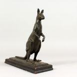 A SPELTER MODEL OF A KANGAROO, on a wooden base. 10.5ins high.