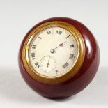 A SMALL CIRCULAR TRAVELLING BEDSIDE CLOCK, with silvered dial and enamel case. 2.75ins diameter.