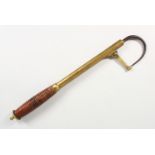 AN EARLY FISHING GAFF by PAPE, NEWCASTLE, with brass and wooden handle. 15ins long.