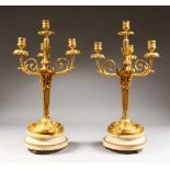 A SUPERB PAIR OF LOUIS XVI ORMOLU AND WHITE MARBLE FOUR LIGHT CANDELABRA, with three scrolling