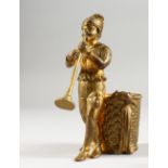 AN ORMOLU MATCH HOLDER, modelled as The Pied Piper, a man standing by a basket playing a pipe.