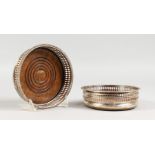 A PAIR OF PLATED CIRCULAR WINE BOTTLE/DECANTER COASTERS, with pierced sided. 5.25ins diameter.