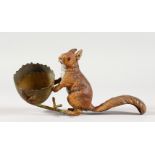 A PAINTED SPELTER FIGURE OF A RED SQUIRREL, standing next to an empty egg. 6ins long.