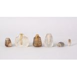 A COLLECTION OF FOUR 19TH CENTURY MUGHUAL INDIAN CARVED ROCK CRYSTAL PERFUME BOTTLES, each with leaf