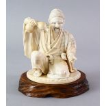 A JAPANESE MEIJI PERIOD CARVED IVORY OKIMONO, the iv ory carved to depict a man pouring from his