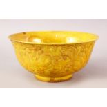 A CHINESE YELLOW GROUND PORCELAIN DRAGON BOWL, the body with dragons chasing pearl in relief,