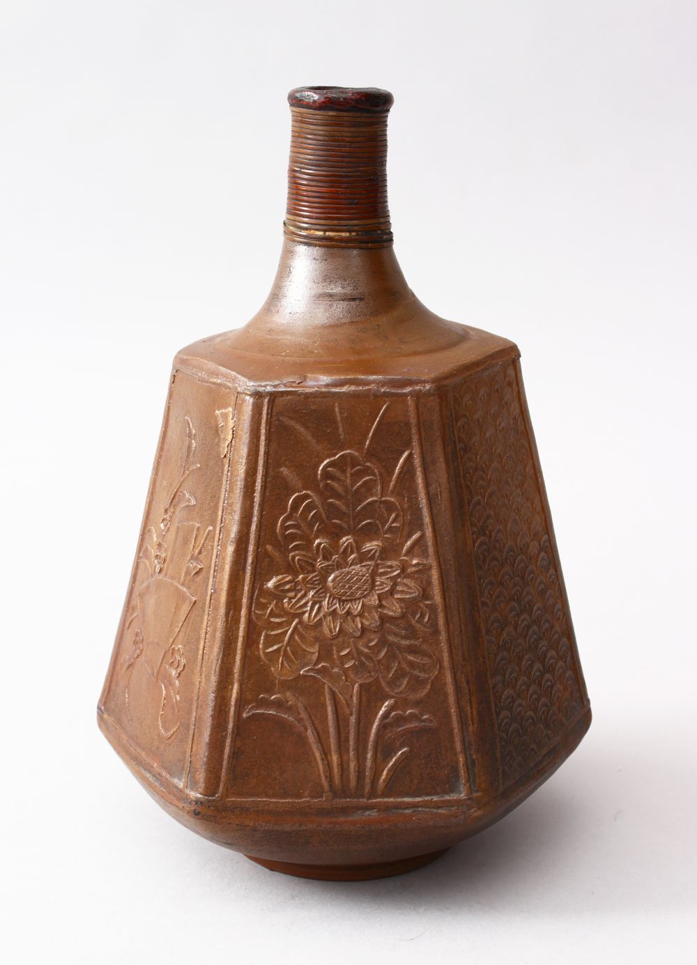 A GOOD JAPANESE MEIJI PERIOD HEXAGONAL STONEWARE SAKE FLASK, the body with panels of carved floral