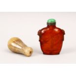 A GOOD 19TH CENTURY CHINESE CARVED AMBER SNUFF BOTTLE, with moulded lion dog handles, with a green