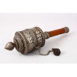 A FINE 19TH CENTURY TIBETAN SILVER PRAYER WHEEL & MANUSCRIPT, the wheel formed from white embossed