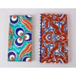 TWO GOOD IZNIK POTTERY TILES, one with a red ground and scrolling decor, 21.5cm x 12.5cm, the