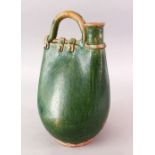 A CHINESE TANG DYNASTY GREEN GLAZED POTTERY POWDER FLASK SHAPED JUG, in the form of a stylized
