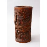 A 19TH CENTURY CHINESE CARVED BAMBOO BRUSH POT, the body of the pot carve in deep relief to depict