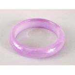 A 19TH / 20TH CENTURY CHINESE CARVED PURPLE AGATE BANGLE, 7.2cm & internal 5.3cm.